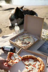 Picnic with pizza and on a blanket on the beach
