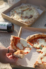 Picnic with pizza and on a blanket on the beach