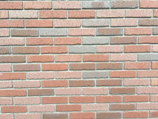 オレンジ色と茶系のレンガ壁の背景テクスチャ