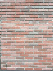 オレンジ色と茶系のレンガ壁の背景テクスチャ