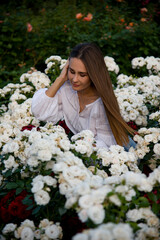 woman with white flowers in rose park