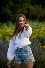 Fototapeta premium woman in a field of yellow and blue flowers