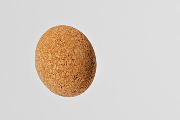 Nice brown egg oval shape cork on the white gray background.Copy space.