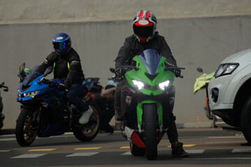Jakarta, Indonesia - 15th July 2022: The green black red sport motorbike is in front of the blue...