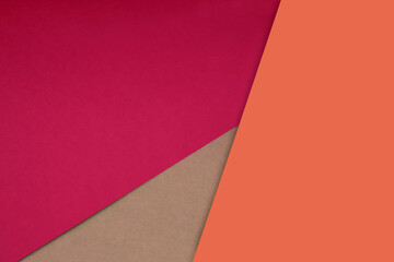 Obraz premium Dark and light, Plain and Textured Shades of neon orange pink papers background lines intersecting to form a triangle shape