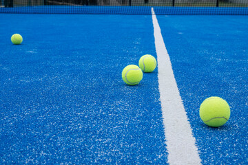 Paddle tennis balls on a paddle tennis court for background