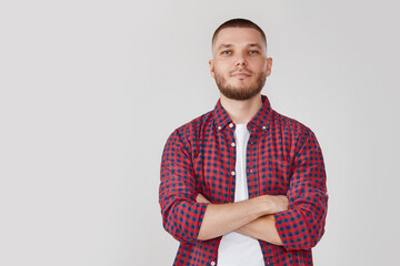 smiling young guy posing with crossed arms