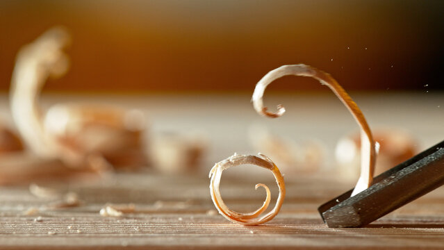Macro shot of chisel cutting the spruce plank.