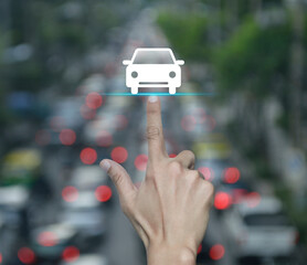 Hand pressing car flat icon over blur of rush hour with cars and road in city, Business transportation service concept