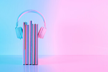 Creative layout made of school books and headphones in vibrant gradient holographic neon colors...