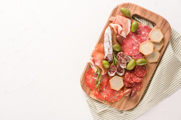 Charcuterie board with variery of sausages - salami, bresaola, proscuitto served with olives and...