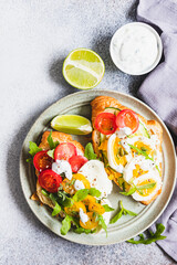 Variety of croissant sandwiches with tomato, cucumber, mozzarella cheese, eggs and mashed avocado with mint and arugula. Open savory sandwiches. Tasty healthy breakfast.