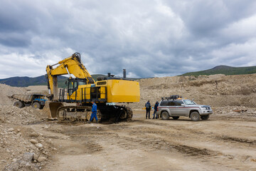 Excavator service at the gold mining site.