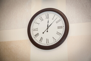 Round wall clock hanging on the wall.