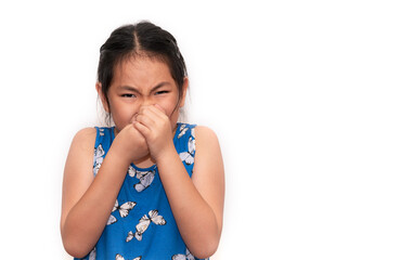 Cute Asian child girl is closing her nose with two hands, an unhappy child feeling bad from the...