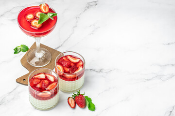 Italian panna cotta dessert with strawberry and mint on a light background. Summer yogurt dessert....