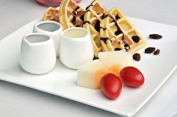 Obraz na płótnie Canvas Waffles with mixed fruit and tea