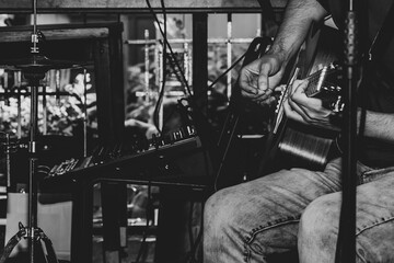 Fototapeta na wymiar Playin guitar concept. Black and white image of live guitar playing.