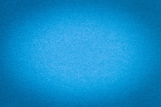 Texture of vintage light blue paper gradient background with dark vignette. Structure of craft cerulean cardboard