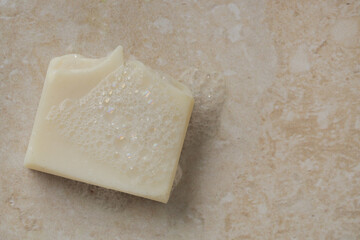 Natural bar soap for healthy skin and hair.
Hydrating cleansing bar on stone textured plain background.
