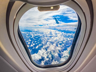 Fototapeta premium View from airplane window onto clouds