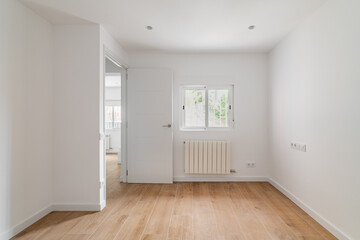 Empty white room with window and natural light. Interior of the freshly renovated room.