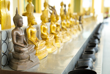 Small brown Buddha statues in Thailand