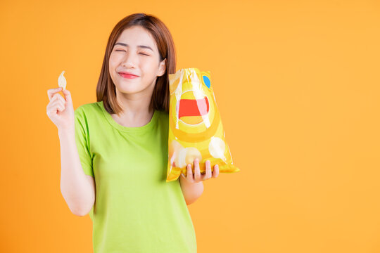 Photo Of Young Asian Girl Eating Snack On Background