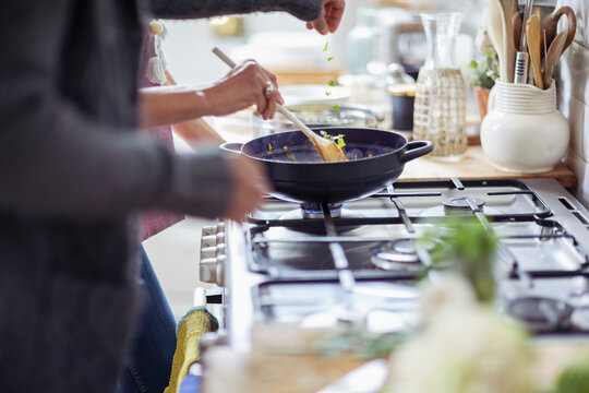 Couple cooking at kitchen stove