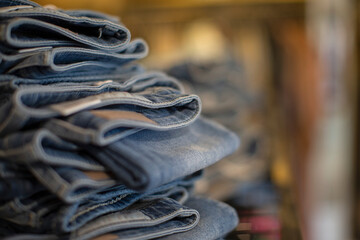 Close up denim jeans stacked in shop