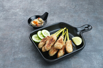 Sate Lilit, traditional Balinese minced chicken satay with lemongrass as skewer, served with sambal matah.
