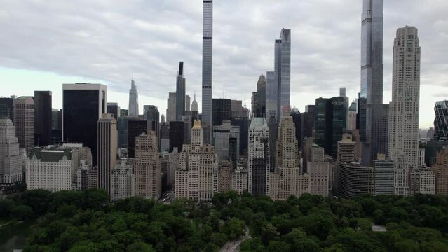 Aerial view over the Central Park, towards supertall skyscrapers in MIdtown, New York, USA - tilt, drone shot