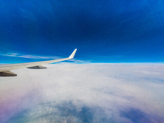 View from an airplane window onto clouds