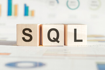The word SQL structured query language, lined with wooden blocks. Wooden block with words SQL -...