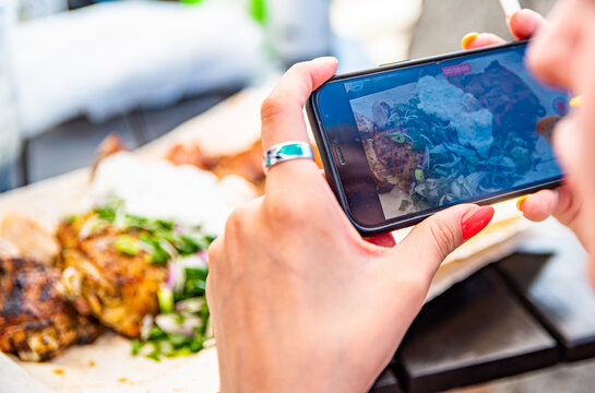 Women hand use mobile phon to take pictures of food or take live video 