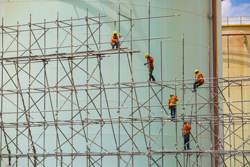 Worker male assembly in progress storage new tank  oil inspection scaffolding