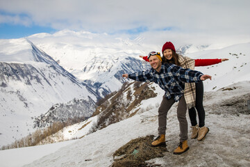 young couple in love enjoying on winter vacation together on the mountain