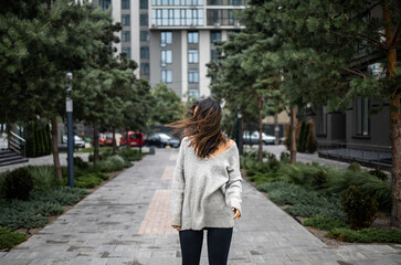 windy weather, hairs close woman's face, sad mood and cold weather. young woman on a windy day. wind blowing hair.