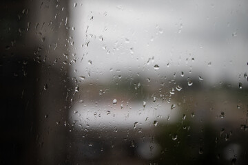 rain on glass. Raindrops on window glass. Selective focus. Rainy city background