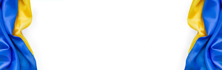 Banner of national flag of Ukraine. Fabric curved in yellow-blue colors ribbons on white background. National symbol of country. Europe. Copy space. Empty space.