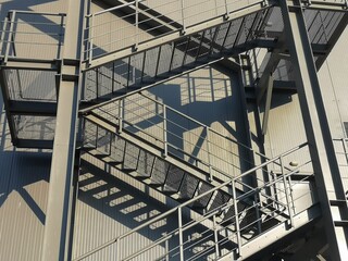 Close up of gray metal external emergency fire staircase. 
