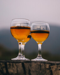 Three glasses of Georgian dry wine close up on the background of mountains. Rest, gourmets, incredible taste, white home alcohol drinks