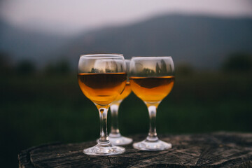 Three glasses of Georgian dry wine close up on the background of mountains. Rest, gourmets, incredible taste, white home wine