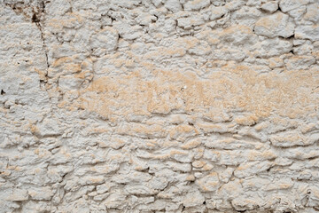 Old rustic traditional limewashed stone wall