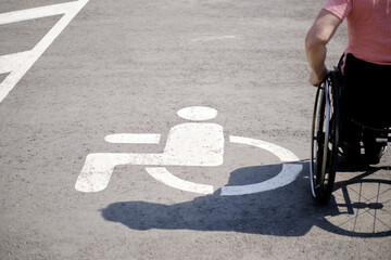 A person with disability Image, symbol of a person using a wheelchair in a public transport parking lot, copy space