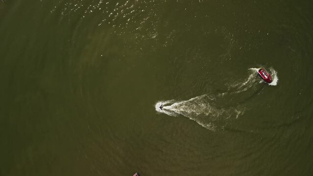 video from a copter, a red boat and a flyboard on the reservoir