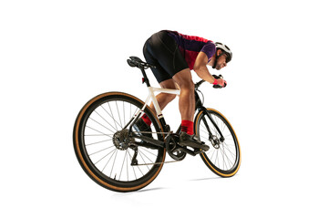 Portrait of man, professional cyclist training, riding isolated over white studio background. Rear...