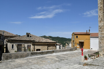 Fototapeta na wymiar A street between the old houses of Tricarico, a rural village in the Basilicata region, Italy.