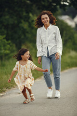 Obraz premium Mother with daughter playing in a summer field
