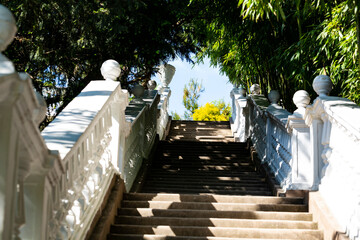 stairs in the park leading up to the blue sky.